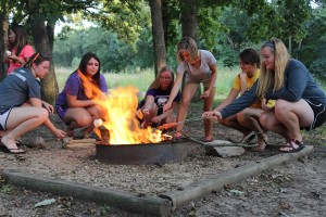 ACT members roast marshmallows for s'mores after a canoeing adventure. 