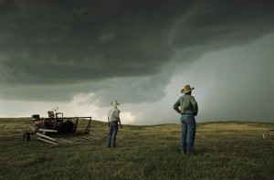 Ranchers watch approaching thunderstorm in the Sandhills of Nebraska.
