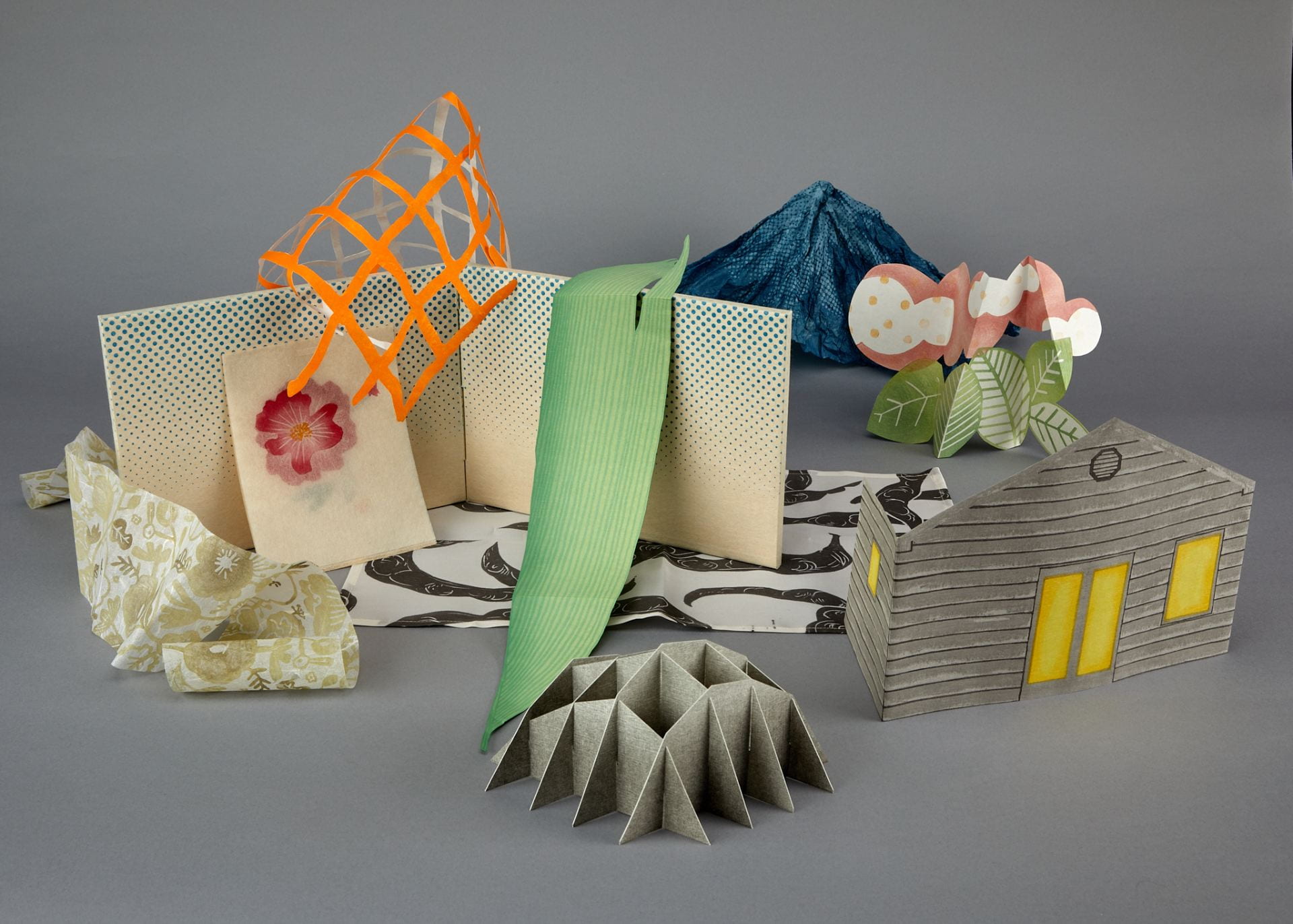 wood+paper+box, "Mise-en-Scène" (2023 Beach Museum of Art Gift Print). Featuring prints cut in various shapes and assembled in a composition. Works are by artists Katie Baldwin, Mariko Jesse, and Yoonmi Nam put together in a box.