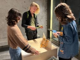 visitors engaged in the "wood+paper+box in your hands" exhibition
