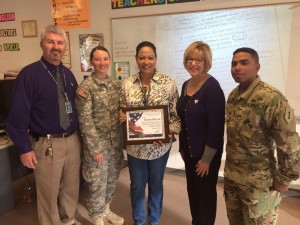 Eunice Rivera, teacher and veteran, is one of four MHS teachers presented with an Education Salute award. Manhattan High  principal Greg Hoyt, First Lt.  Jessica Deason, Tonnie Martinez and First Lt. Anthony Magallanes, presented the awards.