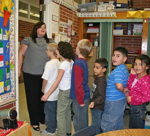 A teacher lines up students for a drill