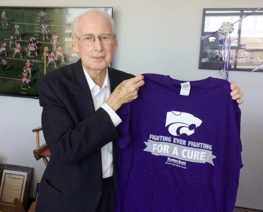 K-State Head Football Coach Bill Snyder holding Fighting for a Cure shirt