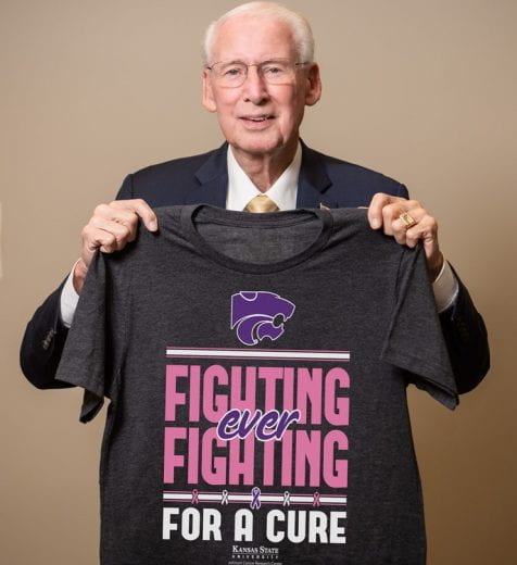Coach Bill Snyder holding 2019 Fighting for a Cure shirt