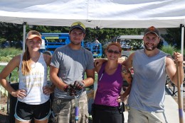 Student interns for The Gardens at Kansas State University help to prepare for the Iris Sale on July 30, 2016. From left to right: Lauren Walz, Andre Luis Ferreira Baldo, Toni Hudspath and Jacob Drentlaw.