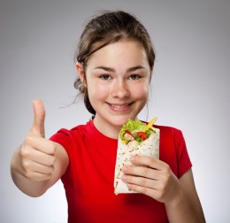 Girl holding sandwiches